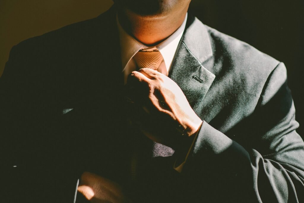 Executive assistant holding neck tie