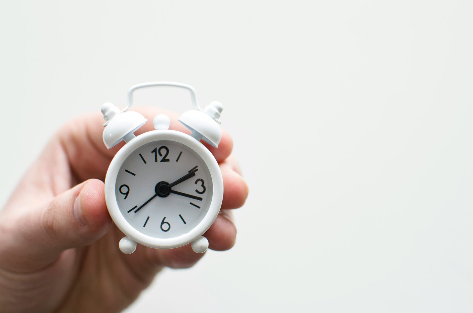 Executive assistant holding clock