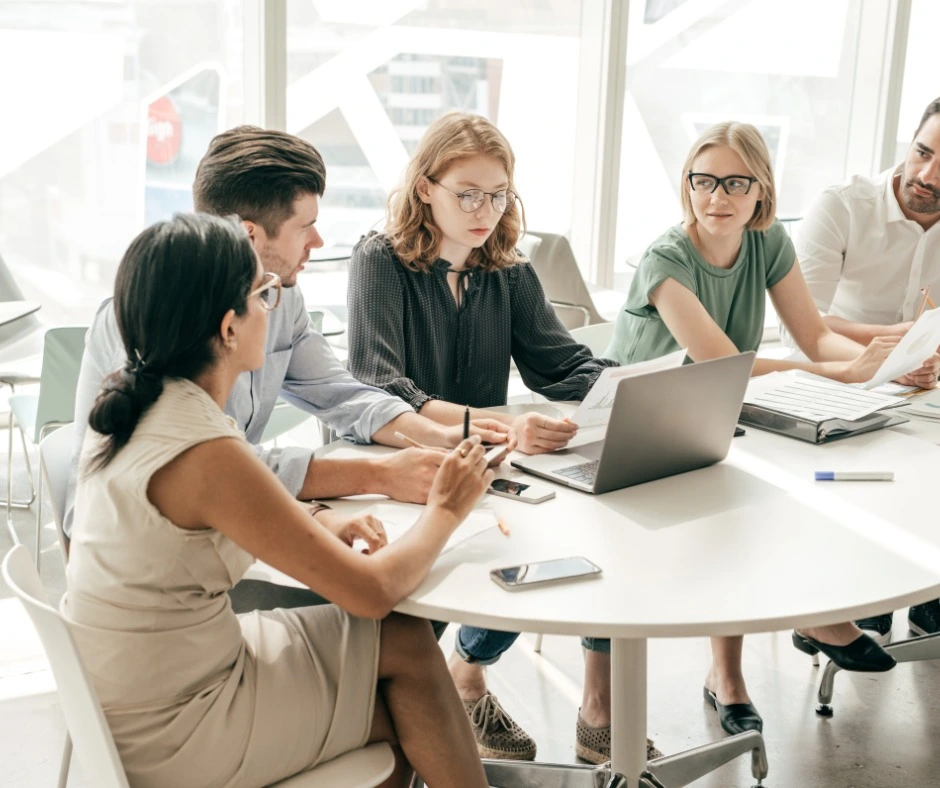 Team gathering for social media manager jobs.