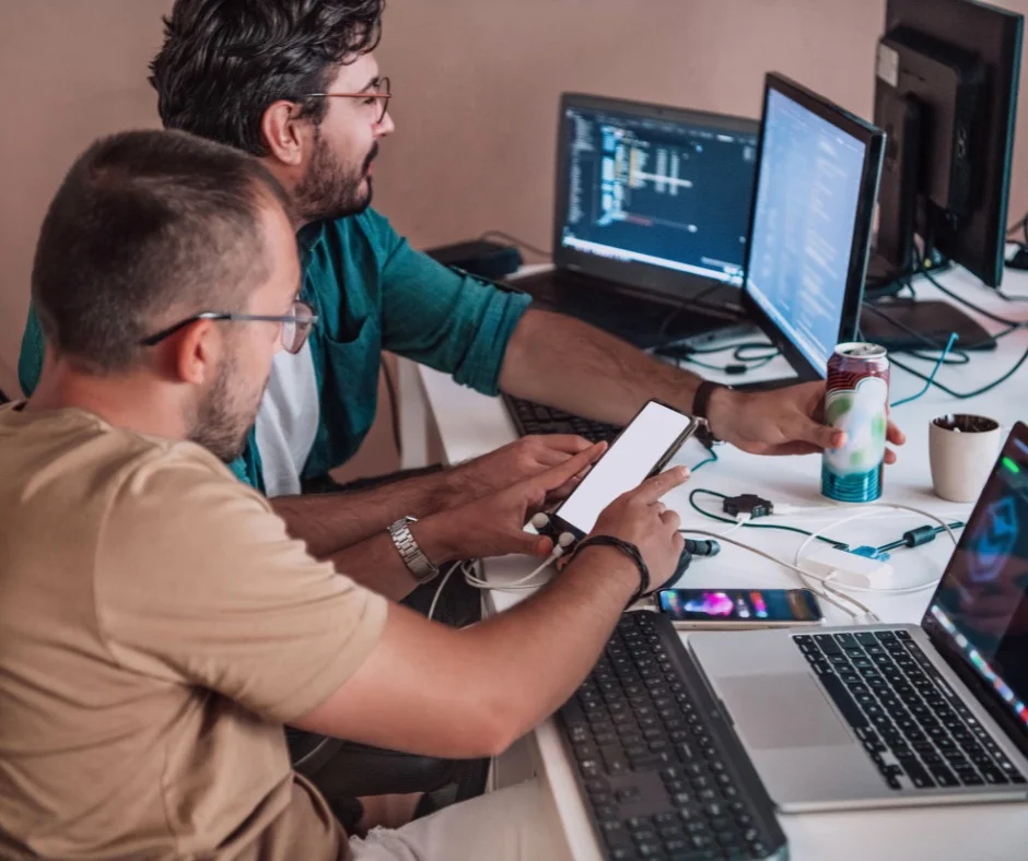 Two employees were working on their computers and cellphones 